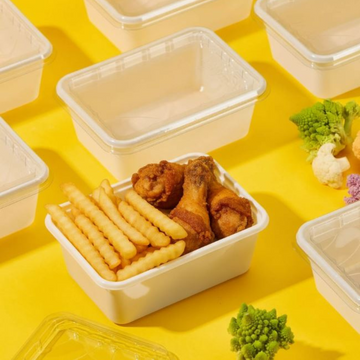 Vaschetta per alimenti bianca con patatine  e alette di polo dentro tra altre vuote